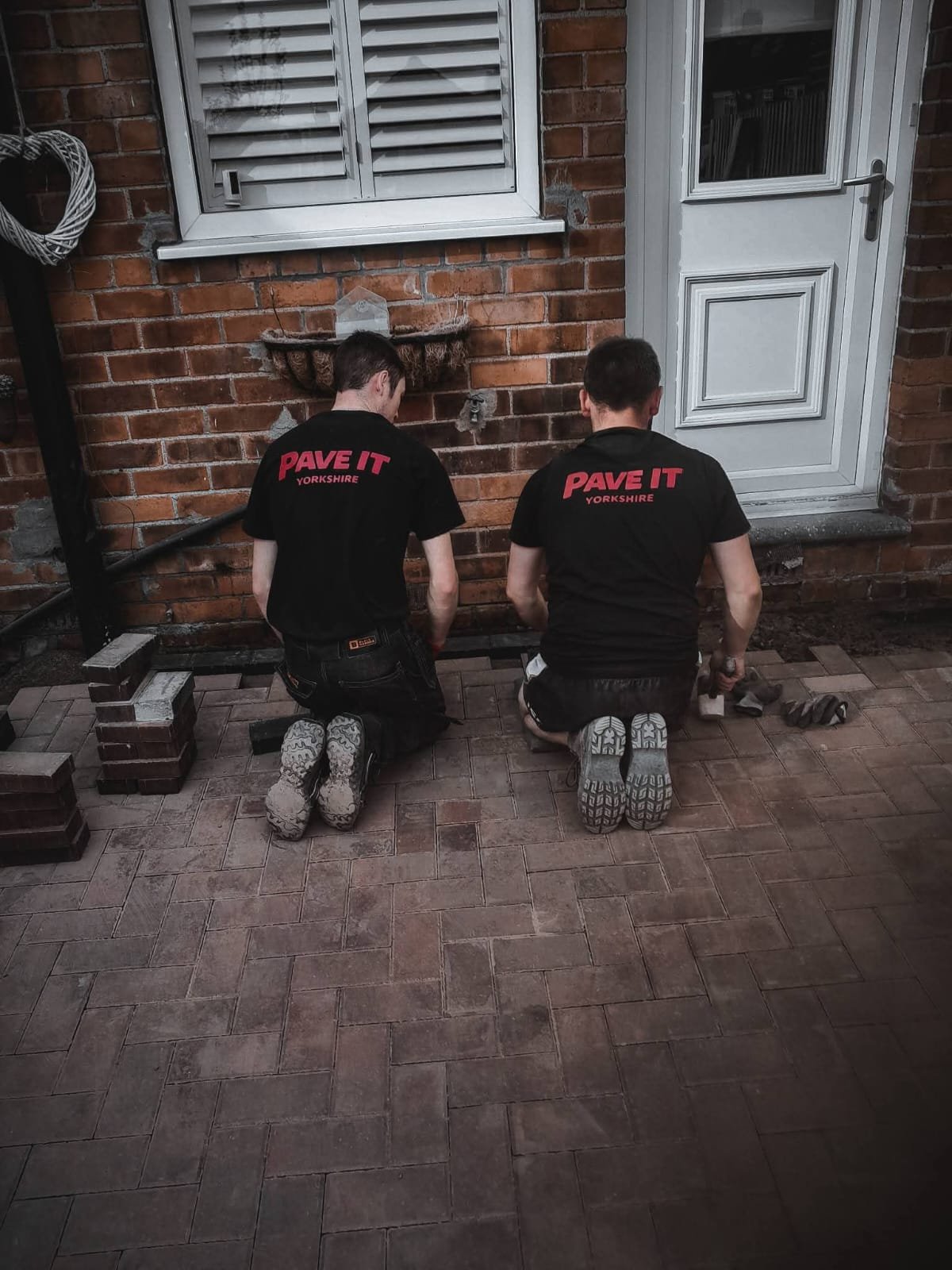 Team laying paving slabs
